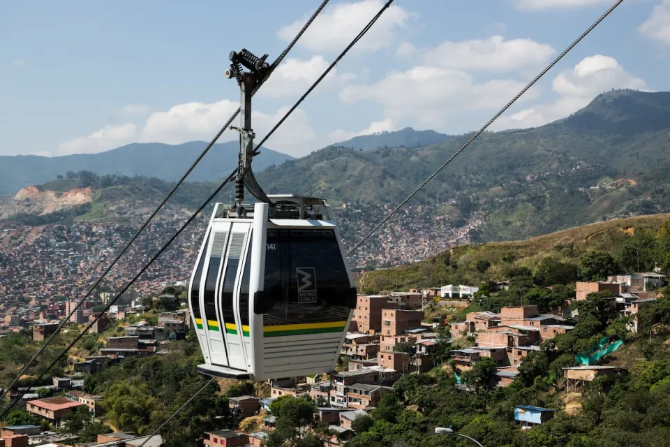 Aerial tram moving along cable in hilly area in Medellin, Colombia.